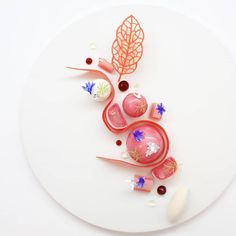 a white plate topped with different types of food on top of a table next to utensils