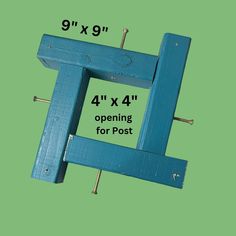 a blue wooden frame with pins in it and measurements for the opening to each post