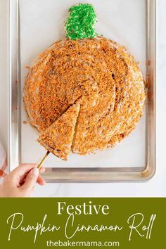 a person holding a piece of food in front of a pan with the words festive pumpkin cinnamon roll on it