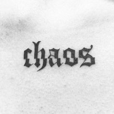 the word chaos written in cursive black ink on a woman's chest