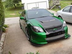 a green car parked in front of a house