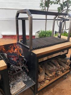 an outdoor grill with firewood in it