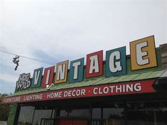 a store front with the words vintage on it's side and an awning