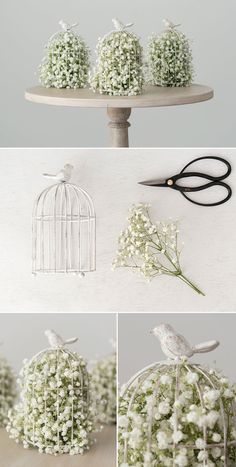 some white flowers are sitting on a table and there is a bird in the cage