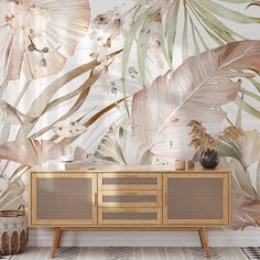 a wallpapered room with tropical leaves and plants on the walls, along with a sideboard