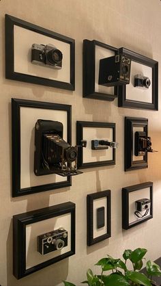 there are many framed pictures on the wall with cameras attached to each one piece of art