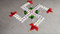 an artistic design made with white, red and yellow flowers on the floor for diwaling