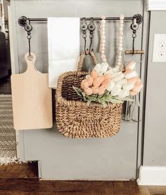 a basket filled with flowers sitting on top of a shelf next to a cutting board