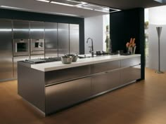 a modern kitchen with stainless steel appliances and wood flooring