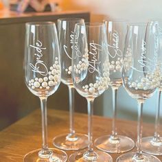 five wine glasses with pearls on them sitting on a table