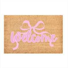 a welcome mat with the word welcome written in pink on top of it and a bow