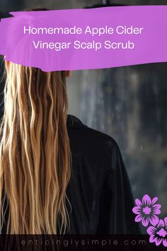 A woman with wet long hair looks in the mirror while standing in a bathroom. This pin features a scalp treatment using apple cider vinegar, showcasing DIY recipes for natural hair care.