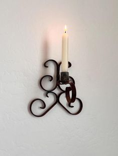 a candle that is sitting on a wall