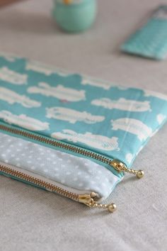 a blue and white zippered pouch sitting on top of a table