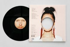 an album cover with a woman's face and man's head