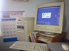 a desktop computer monitor sitting on top of a desk next to a keyboard and mouse