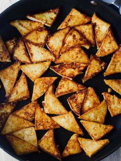 some food is cooking in a skillet on the stove top and ready to be eaten