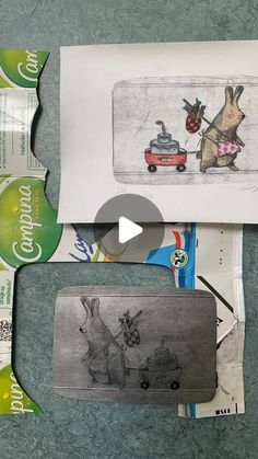 an envelope with some drawings on it next to papers and pencils in front of the envelope