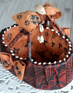 a close up of a cake on a plate with paper flowers and leaves around it