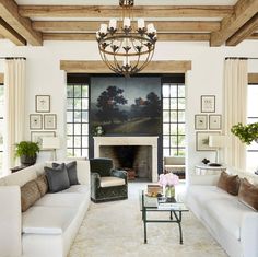 a living room filled with furniture and a fire place in the middle of a room