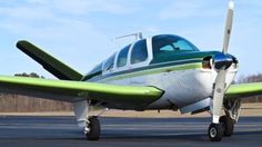 a small airplane sitting on top of an airport runway