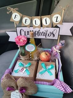 a car trunk filled with gift boxes and flowers next to a sign that says best cupcakes