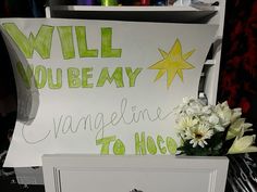 a sign that says will you be my angeline to hog? with flowers in front of it