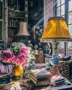 a living room filled with lots of furniture and a lamp on top of a table