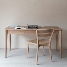 a desk with a chair and a typewriter on it