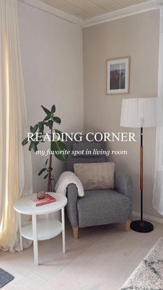 a living room with a gray couch and white table