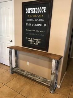 a wooden bench sitting in front of a chalkboard on the wall next to a door