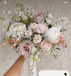 a bouquet of flowers is being held by someone's hand