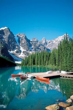 an advertisement for road trip across canada with canoes on the water and mountains in the background