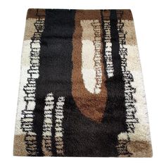 a brown and black area rug on a white background with an abstract design in the middle