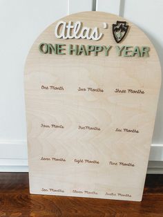 a wooden sign that says atlas one happy year