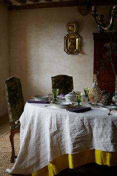 the table is set with plates and cups