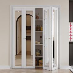 an empty room with white walls and open glass doors on the door, in front of a tiled floor