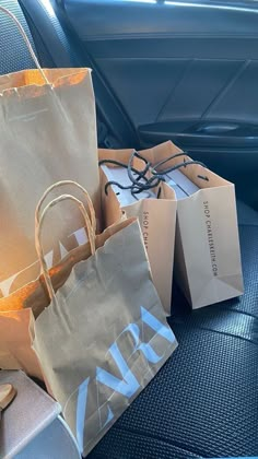 several bags sitting in the back seat of a car