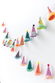 colorful party hats are hanging on a string