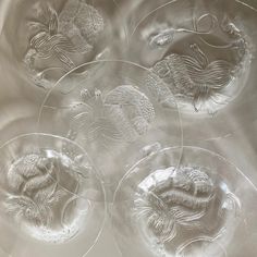 four glass plates with different designs on them