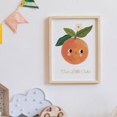 an orange is hanging on the wall next to a wooden toy car and other toys