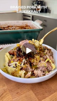 a white bowl filled with food on top of a wooden table