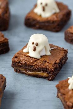 chocolate brownies with white frosting and ghost decorations