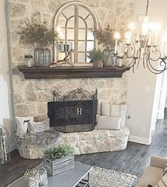 a living room filled with furniture and a fire place next to a wall mounted mirror