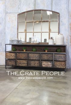 an old dresser with drawers and mirrors on it's sides in front of a concrete wall