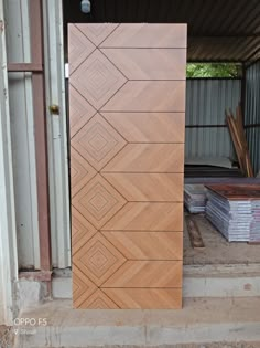 a large wooden door sitting in the middle of a building next to some boxes and other items