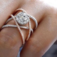 a woman's hand with a diamond ring on top of her finger and an engagement band