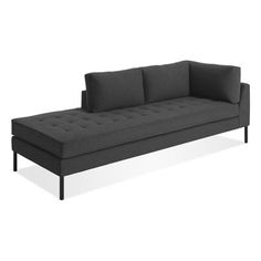 a gray couch sitting on top of a white floor