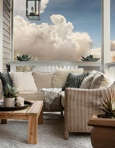 an outdoor living room with wicker furniture and succulents