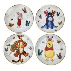 four plates with winnie the pooh designs on them